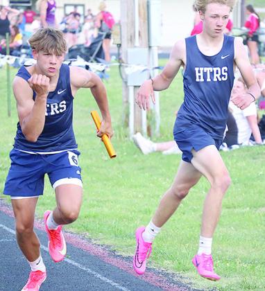 HTRS’ Kameon Dettmann (left) takes the handoff from Axton Wamsley in the boys’ 1600 M. relay. Kameon qualified for State in the 800 M. run. Jasa/Republican