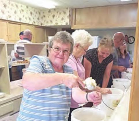 Dipping up pineapple ice cream, Judy Bausch, who has attended Salem for 45 years. “I have made a lot ice cream!” she says.