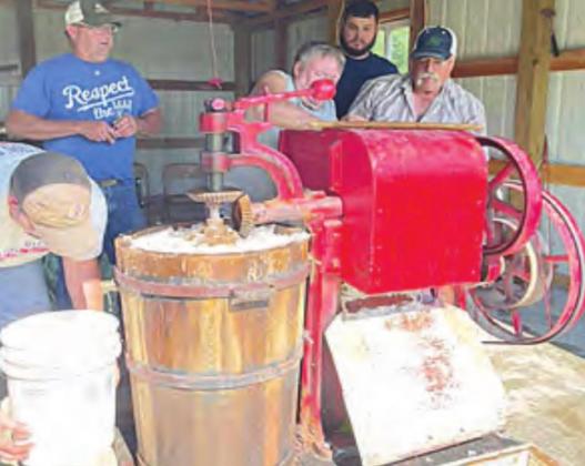 Making ice cream using the 10-gallon freezer. The red is the machine attached to and the waist-high bucket of ice that holds the freezing ice cream. Photo by Katy Kreifel.