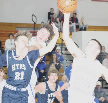 HTRS’ Hunter Frey (#21, left) battles on the boards for a rebound against NCL in subdistrict final play on Thursday night. Frey had 3 rebounds before fouling out. Paula Jasa/Republican