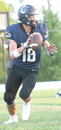 HTRS’ Brandt Leech (#18) looks for an open receiver downfield against Deshler on Friday night. Leech threw for 175 yards with 3 TD’s and just 1 INT. Paula Jasa/Republican