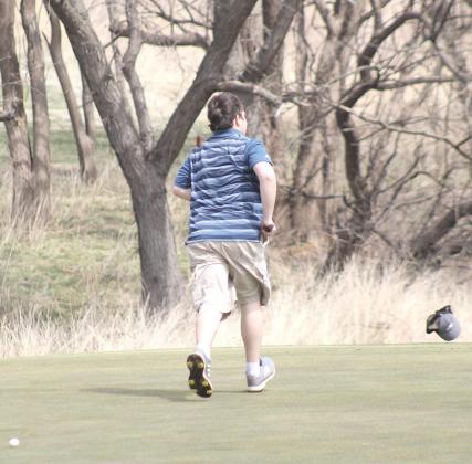 The gusty conditions at the HTRS Invite on Tuesday, April 12th wreaked havoc on the golfers as HTRS’ Carson Refsdal found out when he lost his hat on the #3 green. Paula Jasa/Republican