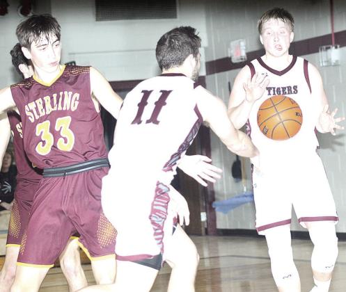LHS’ Brady Bledsaw (#11, left) makes a perfect pass to teammate Caleb Rule (right for an easy bucket. Bledsaw led Lewiston with 24 points against Sterling. Paula Jasa/Republican