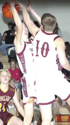 LHS’ Ashton Sanders (left) and Everett Bohling (#10, right) go up for a rebound under the basket. Paula Jasa/Republican