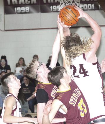 LHS’ Tristen Ray (#24, right) goes up strong under the basket against Sterling in Friday night’s game. Paula Jasa/Republican