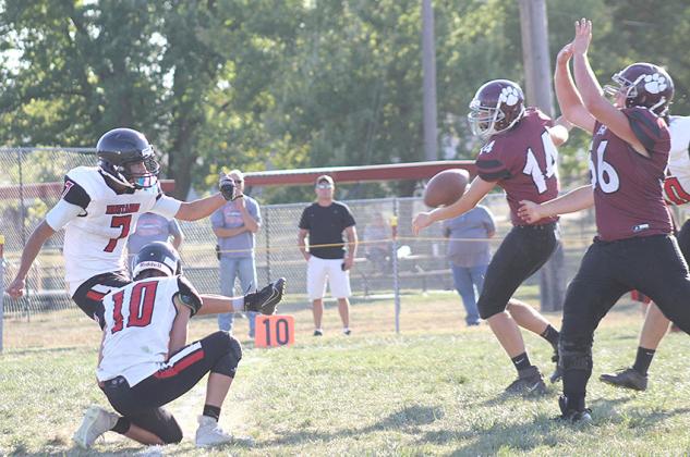 Lewiston’s Ty Arena (#56, right) and Caleb Rule (#14, right) get in the backfield to block a PAT kick against Meridian on Friday afternoon. Paula Jasa/Republican