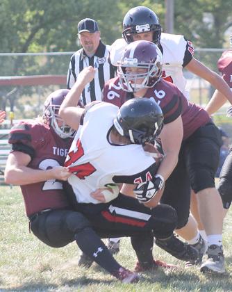 Lewiston’s Dejan Markwort (#26, right) and Tristen Ray (#25, left) bring down a Meridian ball-carrier. Paula Jasa/Republican