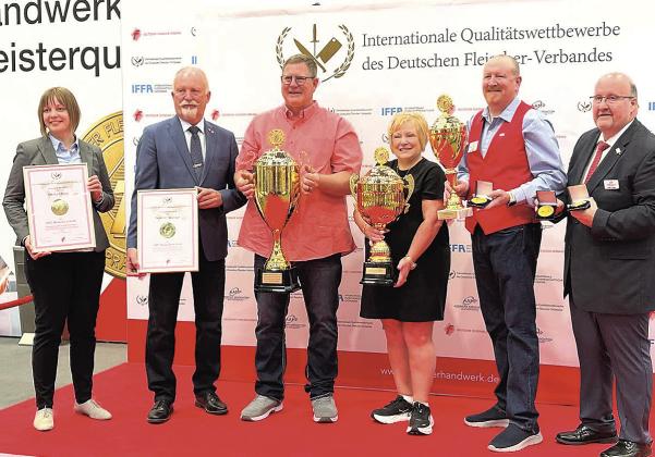 Dennis and Kim Schaardt (center) accept their awards from the German Butcher’s Association in Frankfurt Germany