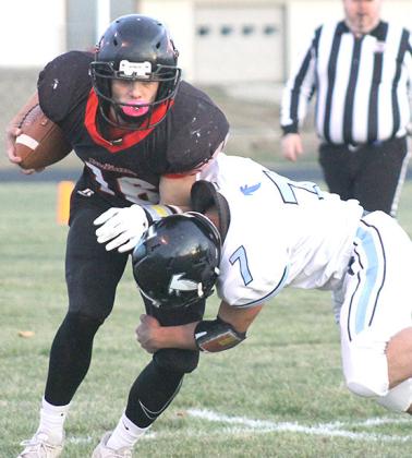 P.C.’s Anthony Kling (#16, left) attempts to shed a Falcon tackler in Friday night’s quarterfinal game. Paula Jasa/Republican