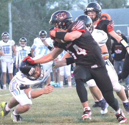 P.C.’s Jett Farwell (#14, right) stiff-arms a would-be Falcon tackler in Pawnee City’s Friday night quarterfinal game. Pawnee City lost to Wilcox-Hildreth, 14-33. Paula Jasa/Republican