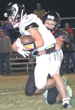 P.C.’s Trey Marteney drags down a Falcon ball-carrier in Friday night’s quarterfinal action. Paula Jasa/Republican