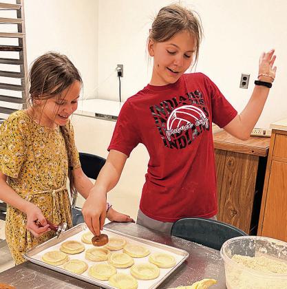 Estelle and Aurora Tyler of Table Rock, adding pizazz as they indent the dough for fillings