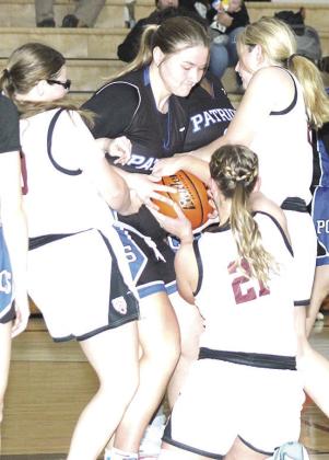LHS’ Vivienne Johnsen (left), DeLanye Currie (right) and Maddie Janssen (#21, center) fight for a loose ball. Paula Jasa/Republican