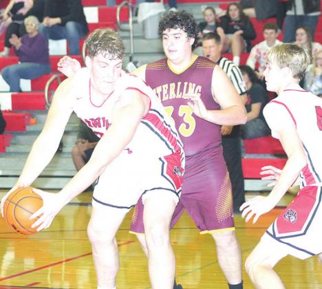 P.C.’s Simon Osborne (left) looks to make a move in the paint as teammate Kylenn Koester (#4, right) looks on. Osborne had several three-point plays in the game. Paula Jasa/Republican