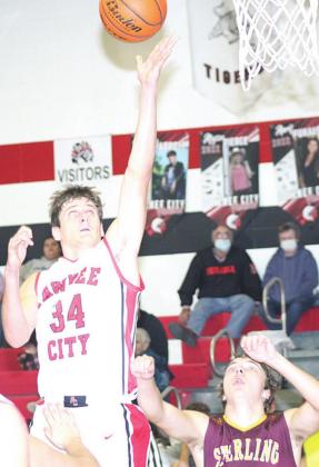 P.C.’s Bryce Gyhra (#34, left) goes up for a shot on the baseline. Bryce scored 8 points against Sterling. Paula Jasa/Republican
