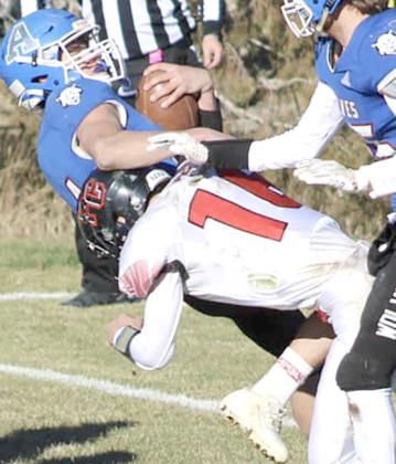 P.C.’s Anthony Kling (#16, right) buries an Arthur County ball-carrier in last Friday’s game. Kling recorded 7 tackles against the Wolves. photo courtesy of Jamie Maloley