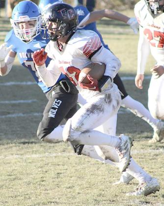 P.C.’s Andy Maloley (#12, right) takes off over the left side of the defense against Arthur County. photo courtesy of Jamie Maloley