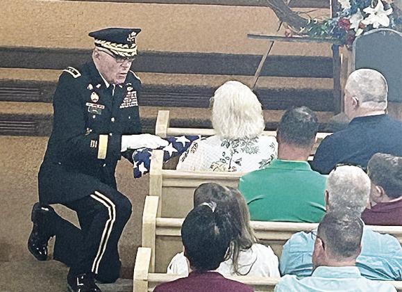 National Guard Major General (Ret.) Charles “Jim” Barr presented a folded U.S. flag to the family of Marvin Behrends, World War II veteran of the 80th Infantry Division, US Army, who died this past year.