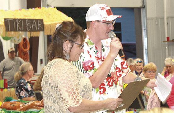 MORE LUAU FUN! - The Live Auction (left) and the Silent Auction (right) attracted many prospective buyers on Saturday night at the Pawnee County EMS Luau Dinner and Auction held at the new Pawnee City Fire Hall.