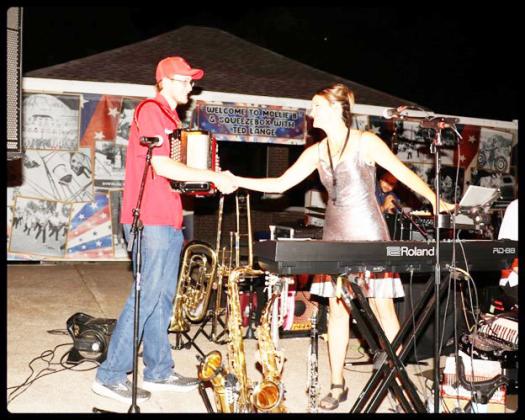 Mollie welcomes Trey Blecha of Table Rock to the stage to play a couple of songs with the band. Photo by Randy Gottula