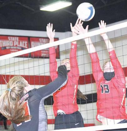 P.C.’s Madison Branek (#11, left) slips a spike past two JCC defenders in Senior Night action on Friday. Paula Jasa/Republican
