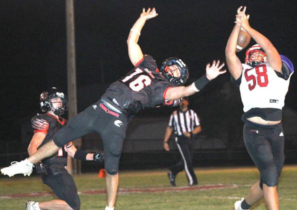 P.C.’s Anthony Kling (#16, center) and Jett Farwell (#14, left) demonstrate how to do a “tip drill” as Kling knocked this pass down and Farwell came up with an amazing catch for an interception. Paula Jasa/Republican