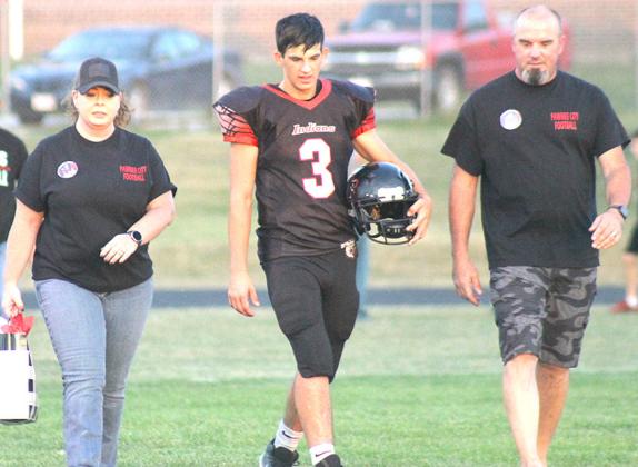 SENIOR NIGHT - P.C.’s Philip Layne (#3, center) walks on to the field with his parents on Parent’s/Senior Night last Friday against Parkview Christian. Pawnee City won the game by a close 18-13 score. Paula Jasa/Republican