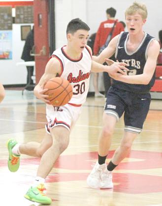 Paula Jasa/Republican P.C.’s Jett Farwell (#30, left) brings the ball up the court with HTRS’ Brogan Dunlap (#12, right) applying the pressure. Farwell led P.C. with 21 points while Dunlap led HTRS with 13 points.