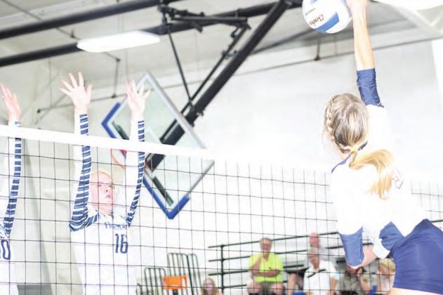 HTRS’ Avery Dierberger (#9, right) launches a spike against Freeman. Paula Jasa/Republican