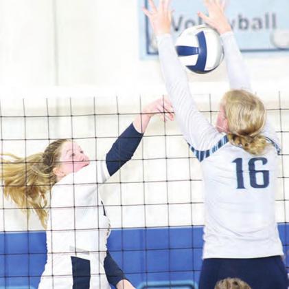 HTRS’ Hannah Koziol (left) puts down a kill against Freeman. Paula Jasa/Republican