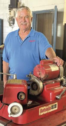 Randy Field with a valve grinder that has given faithful service. This item is on the auction and can be seen at the former Field Ford building in Tecumseh,