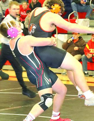 P.C.’s Gauge Schuetz lifts his opponent off the floor for a takedown at Thursday night’s Double Dual. Paula Jasa/Republican