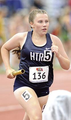HTRS’ Eden Duryea takes her turn with the baton in the Class D girls’ 3200 M. relay on Friday. Photo courtesy of Luke Nichols/ Beatrice Daily Sun