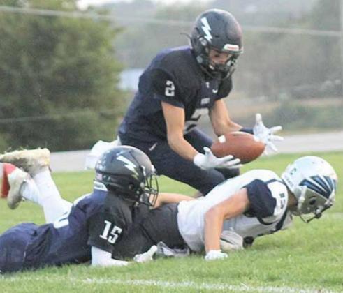 HTRS’ Donovan Kostecka (#2) gets his hands on a fumble recovery after Ethan Dierberger (#15) strips it and then returns it for some yardage. Paula Jasa/Republican