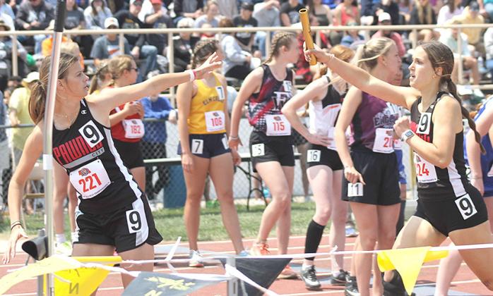 P.C.’s Mallory Branek taking the handoff from Logan Maloley in the 3200 M.R.