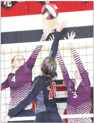 P.C.’s Logan Maloley (#15, center) goes up at the net against Lewiston’s Emma deKoning (#4, left) and Katelyn Sanders (#3, right). Paula Jasa/Republican