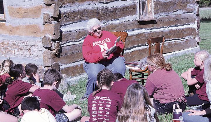 Lewiston 5th grade students listen attentively as Pawnee City Historical Society volunteer Nancy Tennant reads about Abraham Lincoln