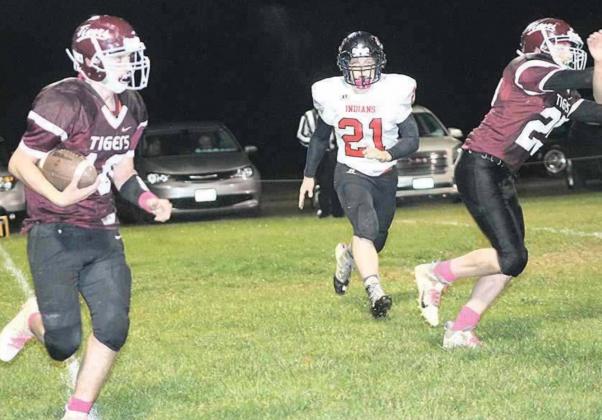 Lewiston’s Mathew Barker (#10, left) calls his own number on a carry as teammate Tristen Ray (#25) blocks out front and P.C.’s Clayton Shook (#21, center) pursues. Paula Jasa/Republican