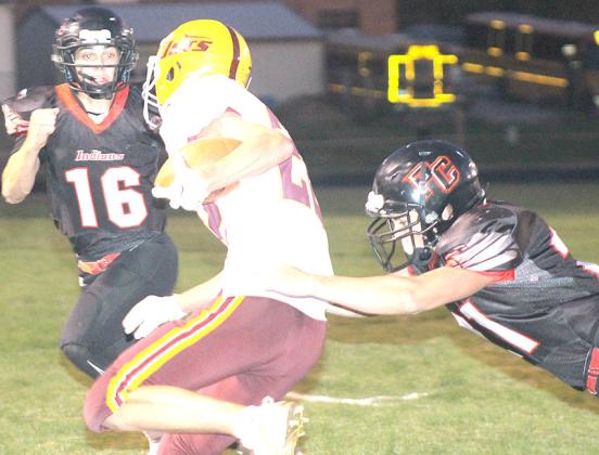Pawnee City’s Wyatt Blank (right) goes for the tackle on a Sterling ball-carrier as Anthony Kling (#16, left) looks to help out. Paula Jasa/Republican