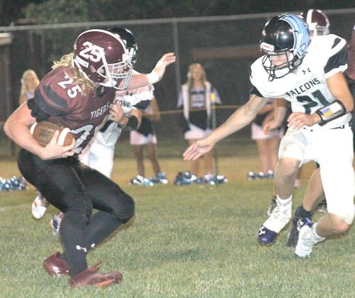 LHS’ Tristen Ray (#25, left) picks his way through the Wilcox-Hildreth defense on Friday night. Ray carried 26 times for 130 yards in the game. Paula Jasa/Republican