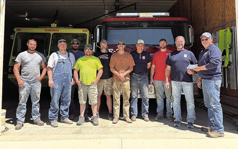 Jeff Wehrbein, Farmers Cooperative Burchard Location Manager presents grant check to DuBois Fire Department members.
