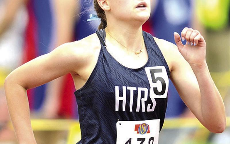 HTRS’ Grayson Sherman runs her leg of the Class D girls’ 3200 M. Relay on Friday. The Lady Titans made it to the podium with their school record time of 10:15.56. Photo courtesy of Luke Nichols/Beatrice Daily Sun