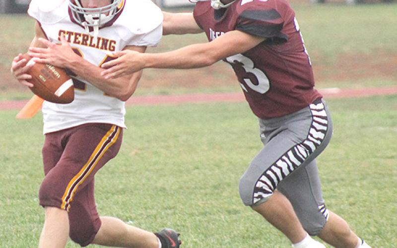 LHS’ Kaden Wagner (#23, right) makes a good tackle on a Sterling runner. Wagner had some great stops in the game including a touchdown-saving tackle. Paula Jasa/Republican