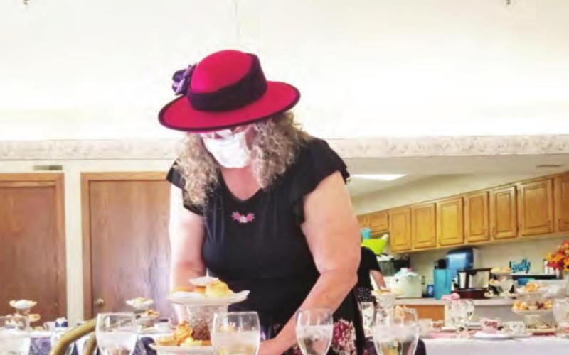 Suzanne Ellis helps set the tables