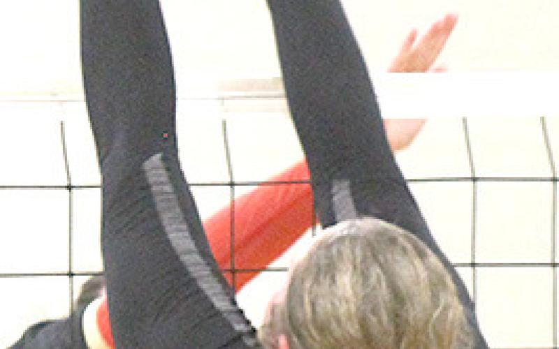 Pawnee City’s Riana McAhon (#22) gets her hands on a block, but it goes just slightly out of bounds against JCC. Paula Jasa/Republican