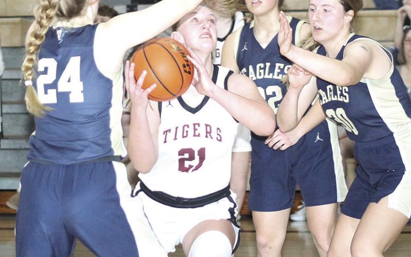 LHS’ Maddie Janssen (#21, center) goes up in high traffic in the lane against Omaha Christian Academy on Saturday. Janssen scored 9 points in the Lady Tigers’ 3735 comeback triumph over OCA and went to the free throw line several times. Paula Jasa/Republican