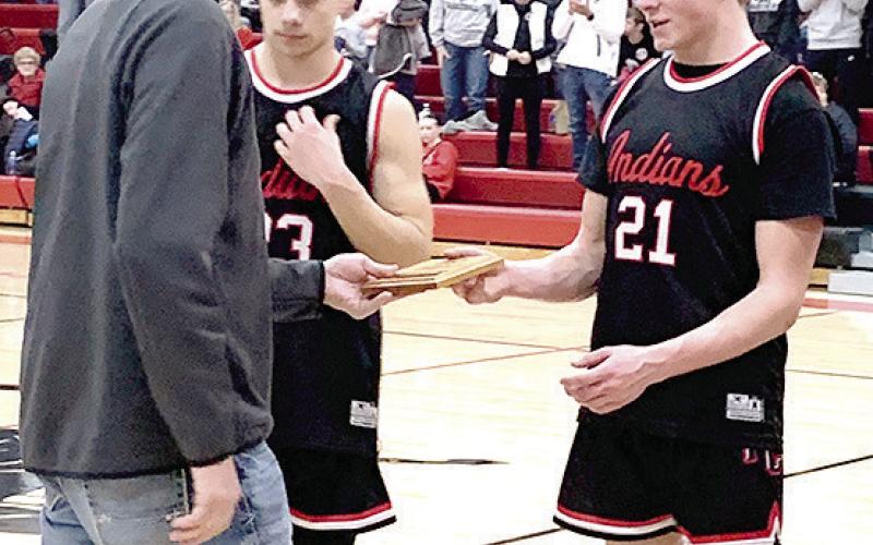 Paula Jasa/Republican PAWNEE CITY AT PIONEER – Pawnee City’s Trey Marteney (#21, right) and Anthony Kling (#23, left) accept the 4th place Pioneer Conference Basketball plaque on Saturday. See page 5 for story.