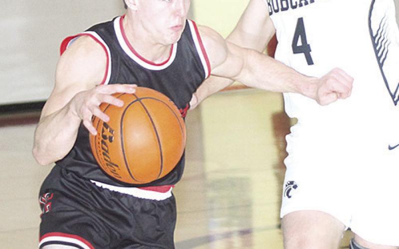 P.C.’s Jett Farwell (left) drives past an E-M-F defender early in the game on Saturday. Farwell finished the game with 12 points. Paula Jasa/Republican