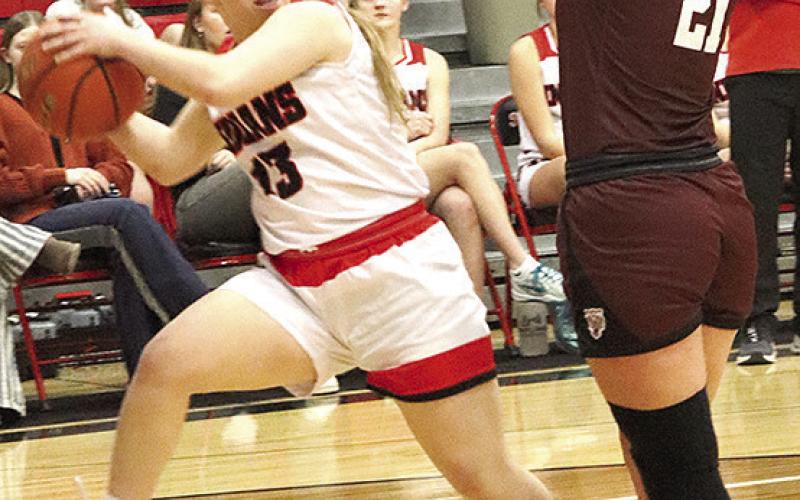 P.C.’s Ericca Gyhra (#13, left) makes an assist to a teammate on the fast break as LHS’ Maddie Janssen (#21, right) defends. Paula Jasa/Republican