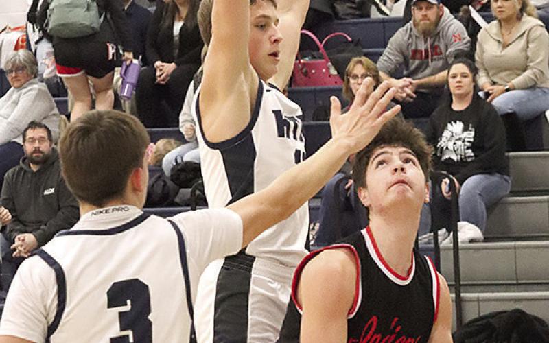 P.C.’s Tyler Tegtmeier (#13, right) goes up for a baseline shot against HTRS’ Emmett Glathar (center) and Kameon Dettmann (#3) last Tuesday. Paula Jasa/Republican